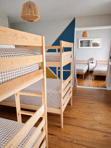 a bedroom with two bunk beds and a living room at chambres randonneurs in Plestin-les-Grèves