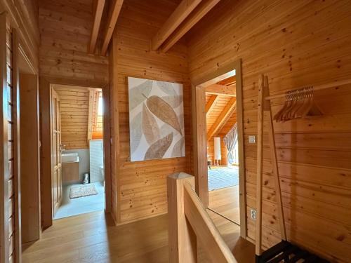 a room with wooden walls and wooden flooring at Chata Mila in Veľká Lomnica