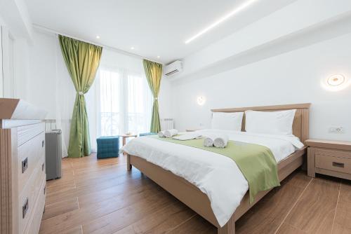 a bedroom with a large white bed and a window at Escape Vama Veche in Vama Veche