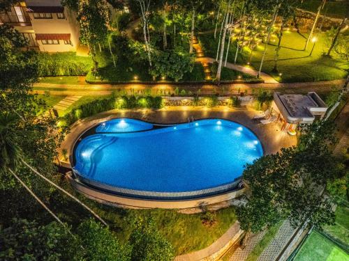an overhead view of a swimming pool at night at Sterling Lontano Waterfront Wayanad in Meppādi