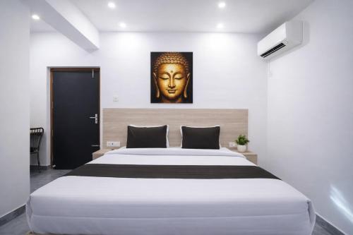 a bedroom with a large bed with a large headboard at Hotel Shubh Bodhi in Bodh Gaya