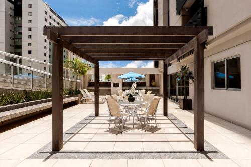a patio with a table and chairs on a balcony at S4 Hotel Águas Claras in Brasilia
