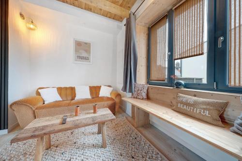 a living room with a couch and a table at Appartement rénové centre Crozon in Crozon