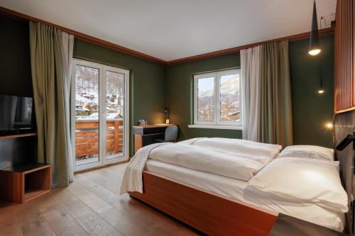 Postel nebo postele na pokoji v ubytování Amber Ski-in/out Hotel & Spa