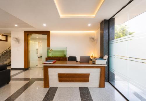 an office with a desk in the middle of a room at Hotel Meridian Sector 132, Near Max Hospital in Noida