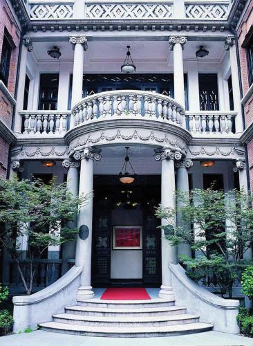 a large white building with a staircase leading to the front door at The Langham, Shanghai, Xintiandi in Shanghai