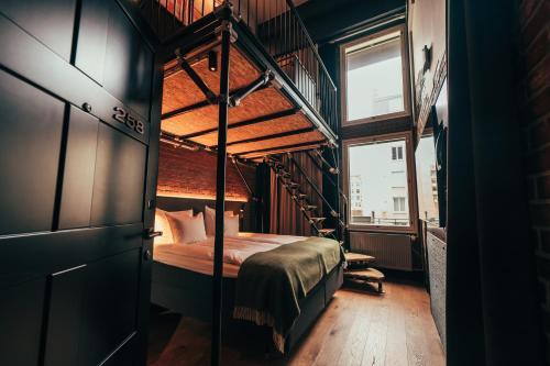 a bedroom with a bunk bed and a staircase at Clarion Hotel Mestari in Helsinki