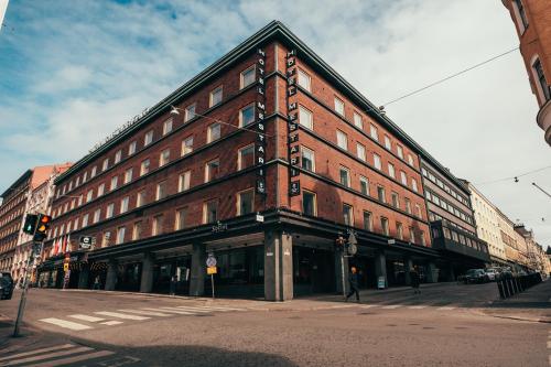 a large brick building on the corner of a street at Clarion Hotel Mestari in Helsinki