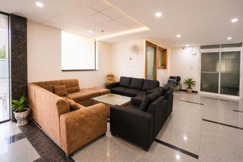 a living room with two couches and a table at Hotel Meridian Sector 132, Near Max Hospital in Noida