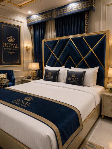 a bedroom with a large bed with a blue headboard at Royal Boutique Hotel Lahore in Lahore