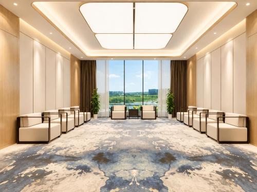 an empty waiting room with chairs and a large window at Radisson Hotel, Beijing DaXing Airport in Beijing