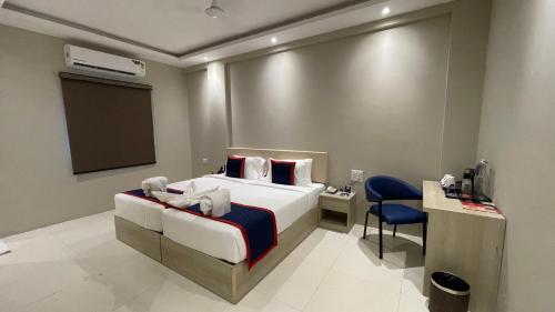 a hotel room with a bed and a tv at Surendra Landmark By Spree Hotels Bhopal in Bhopal