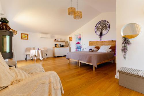 a living room with a bed and a table at Le Spa des lavandes panoramique in Valensole