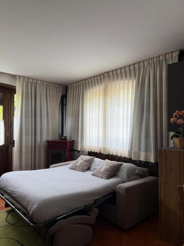 a bedroom with a bed and a window at Mountain Apartments Tarvisio in Tarvisio
