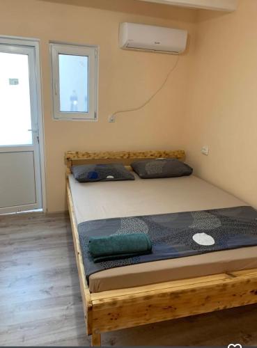 a bedroom with a wooden bed in a room at Comfort in Reni