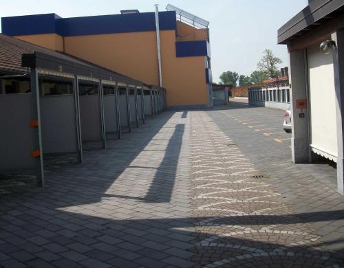 an empty parking lot next to a building at Hotel Motel 2 in Tortona