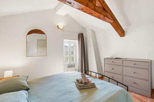 a bedroom with a bed with a stuffed animal on it at La Villa Andéria in Callian
