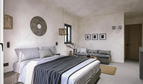 a bedroom with a large bed and a couch at Clementina Hill in Naousa