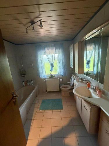 a bathroom with a tub and a sink and a bath tub at Haus Franz in Zandt