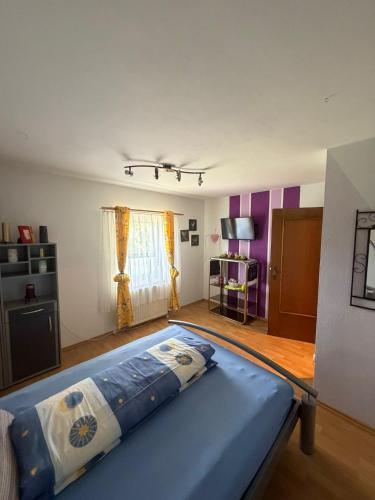 a bedroom with a blue bed in a room at Haus Franz in Zandt