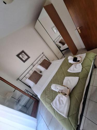 an overhead view of a room with two beds with towels at nikol villa elani in Siviri