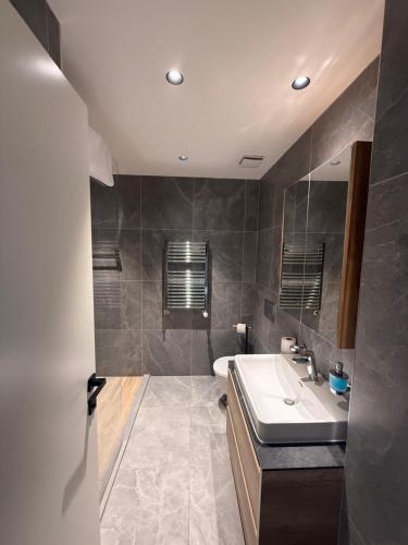 a bathroom with a sink and a mirror at BW LUX STUDIO-Belgrade Waterfront in Belgrade
