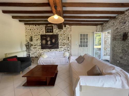 a living room with a couch and a table at Chez cazalets in Susmiou