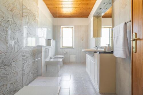 a bathroom with a toilet sink and a shower at Casa Vacanza Iris in Perdaxius