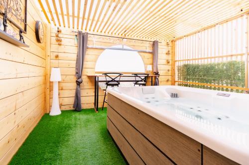 a bathroom with a large tub in a wooden house at Le Spa des lavandes panoramique in Valensole
