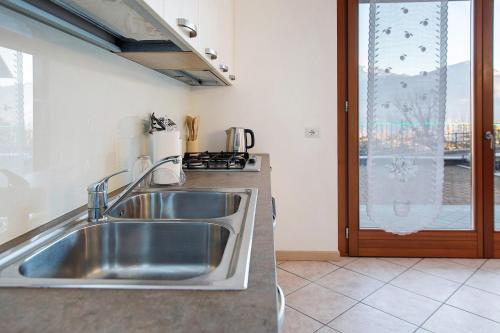 a kitchen with a stainless steel sink and a window at Studio Apartment Lake and Relax in Gravedona