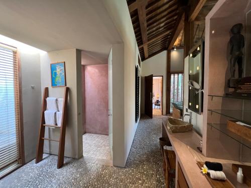 a bathroom with a sink and a mirror at The Purist Villas & Spa Ubud in Ubud