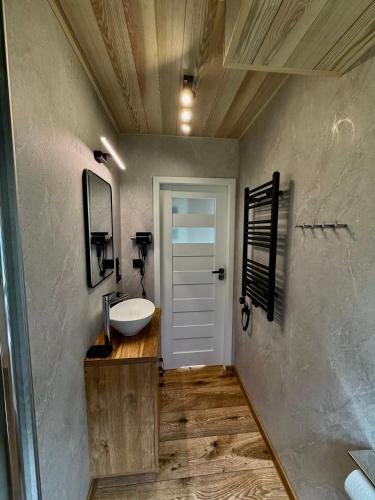 a bathroom with a sink and a mirror at Przystań Caryńska w Polańczyku in Polańczyk