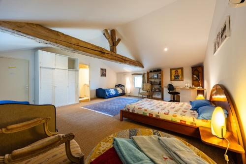 a bedroom with a bed and a living room at Chambres d'hôtes Château Cajus in Saint-Germain-du-Puch