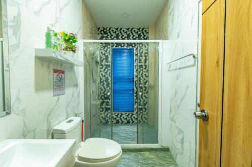 a bathroom with a shower and a toilet and a sink at Richpoolvilla Pattaya in Jomtien Beach