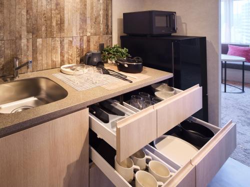 a kitchen with a sink and a counter at Minn Namba South in Osaka