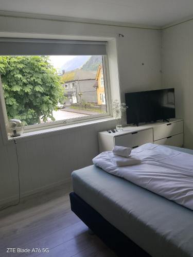 a bedroom with a bed and a large window at Apartment in Stryn in Stryn