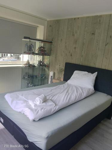 a large bed with white sheets and pillows at Apartment in Stryn in Stryn