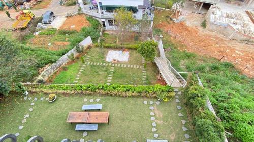 an aerial view of a garden with a table and benches at Zanya villa & coffee in Da Lat