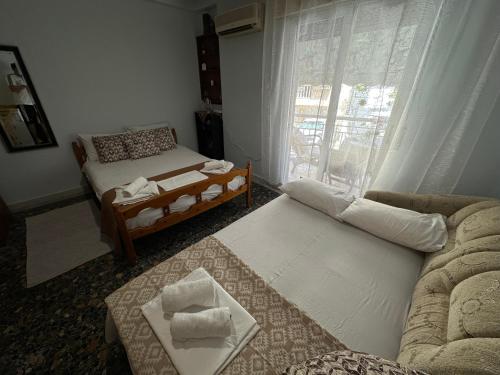 a living room with a couch and a table at LADY E. in Kavála