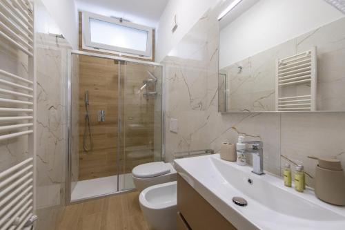a bathroom with a shower and a toilet and a sink at Villa CristAl in Praiano