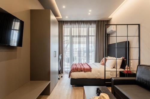 a bedroom with a bed and a couch at Au Piree by Calon in Piraeus