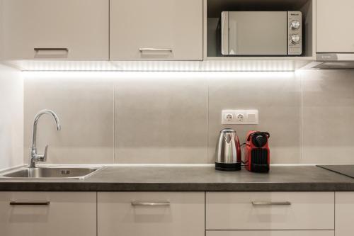 a kitchen with a sink and a microwave at Au Piree by Calon in Piraeus