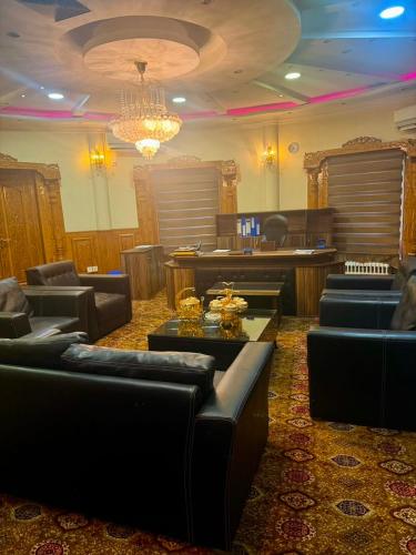 a living room with couches and a chandelier at Kite Residence - Secure Stay in Kabul