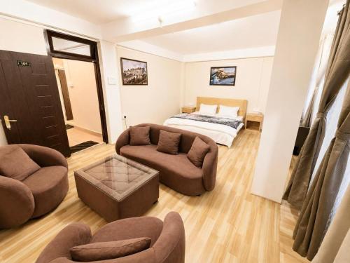 a living room with a couch and a bed at Ananda Homestay in Tawang