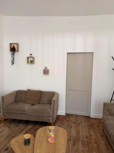 a living room with a couch and a table at Maison des Capucins in Nérac