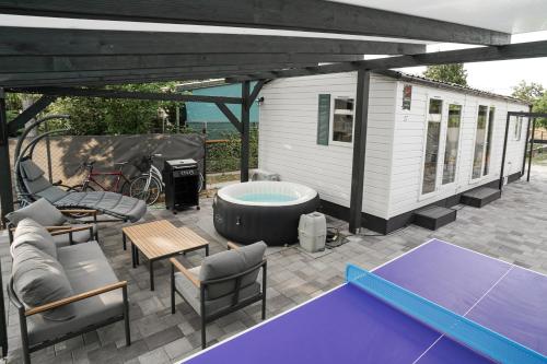 a pavilion with a hot tub and a ping pong at Diófa Vendégház in Pilismarót