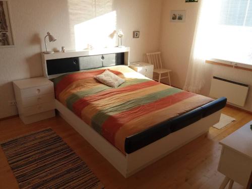 a bedroom with a large bed in a room at Suns Tupa - Travellers Marmalade in Siikalatva