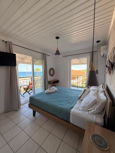 a bedroom with a bed and a view of the ocean at Vaso Alykanas Studios in Alikanas