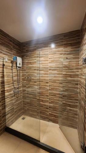 a shower with a glass enclosure in a bathroom at Utime Riverside Kanchanaburi in Ban Yang (2)