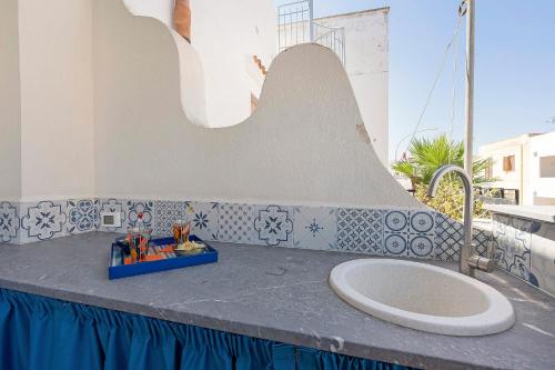 a bathroom with a sink on top of a counter at Suite Horizon Marine in San Vito lo Capo